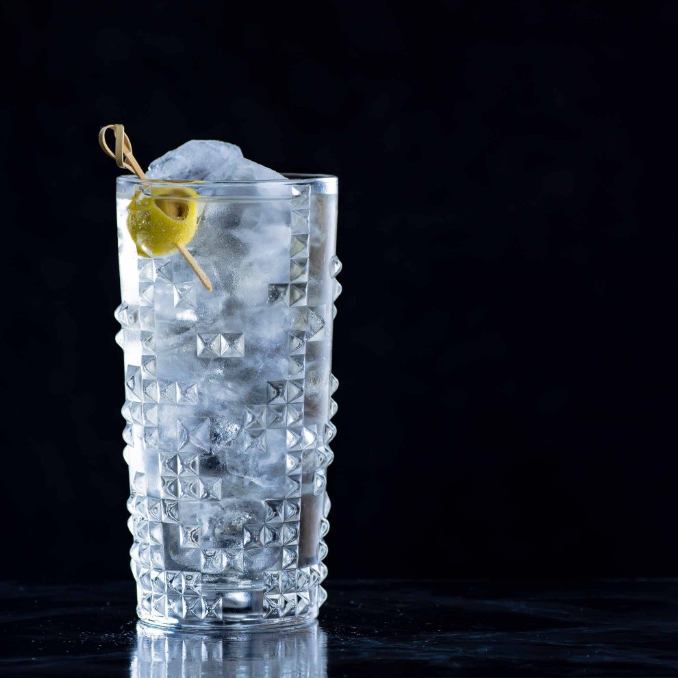 Ein Dirty Martini Highball aus Gin, weißem Wermut, Sherry, Oliven-Lake & Soda oder Tonic.